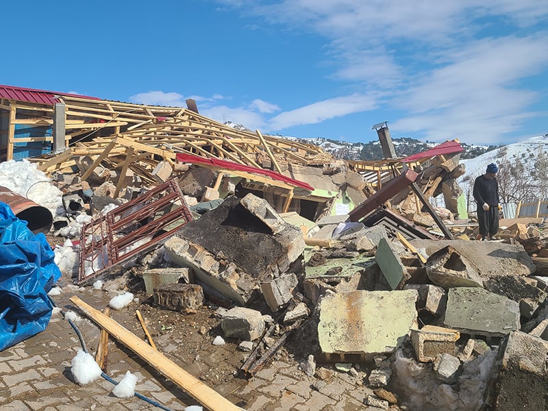 People in Turkey search through the rubble of their village. 