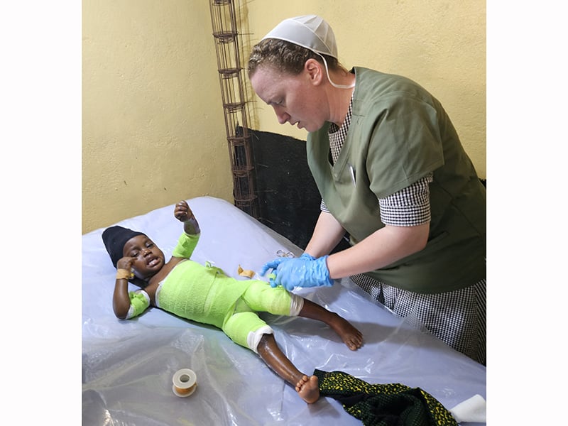 Medical care for child in green.