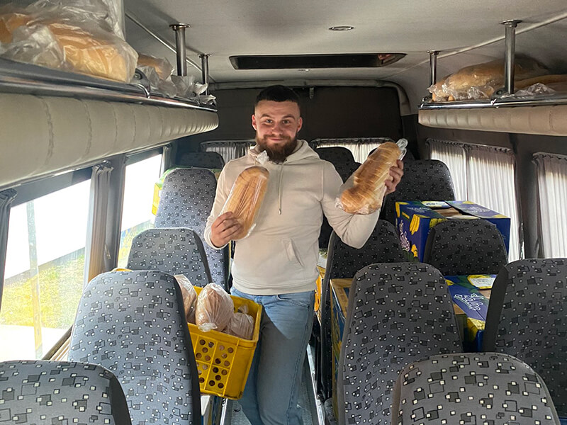 A CAM worker fills his van with bread for refugees.