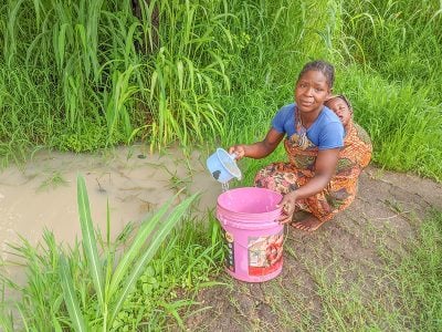 Before a LifePump™ was installed in her community, this mother gathered water from a muddy waterhole.